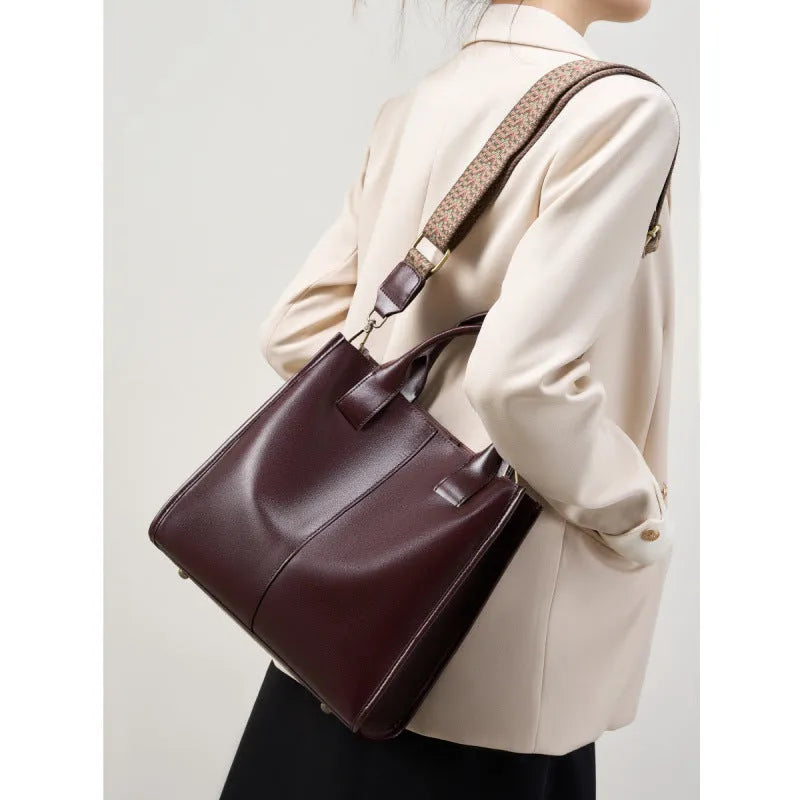 Women's genuine leather shoulder tote bag in black colour showing bucket design and polyester lining
