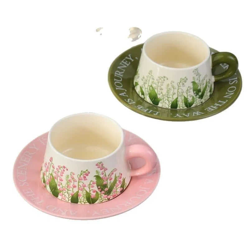 Ceramic coffee cup and saucer set for couples with two cups, saucers, and spoons.
