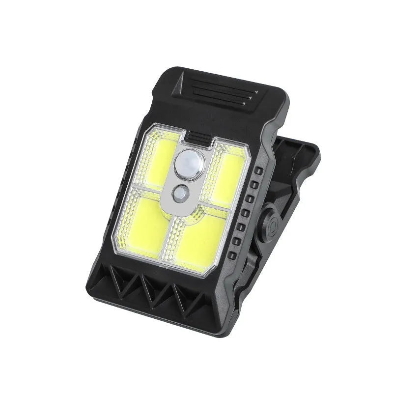White ABS plastic motion sensor clip lamp with LED light, shown attached to a cupboard door edge.