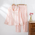 Women's cotton pajamas set in pink and beige colours showing long sleeves and trousers-length pants
