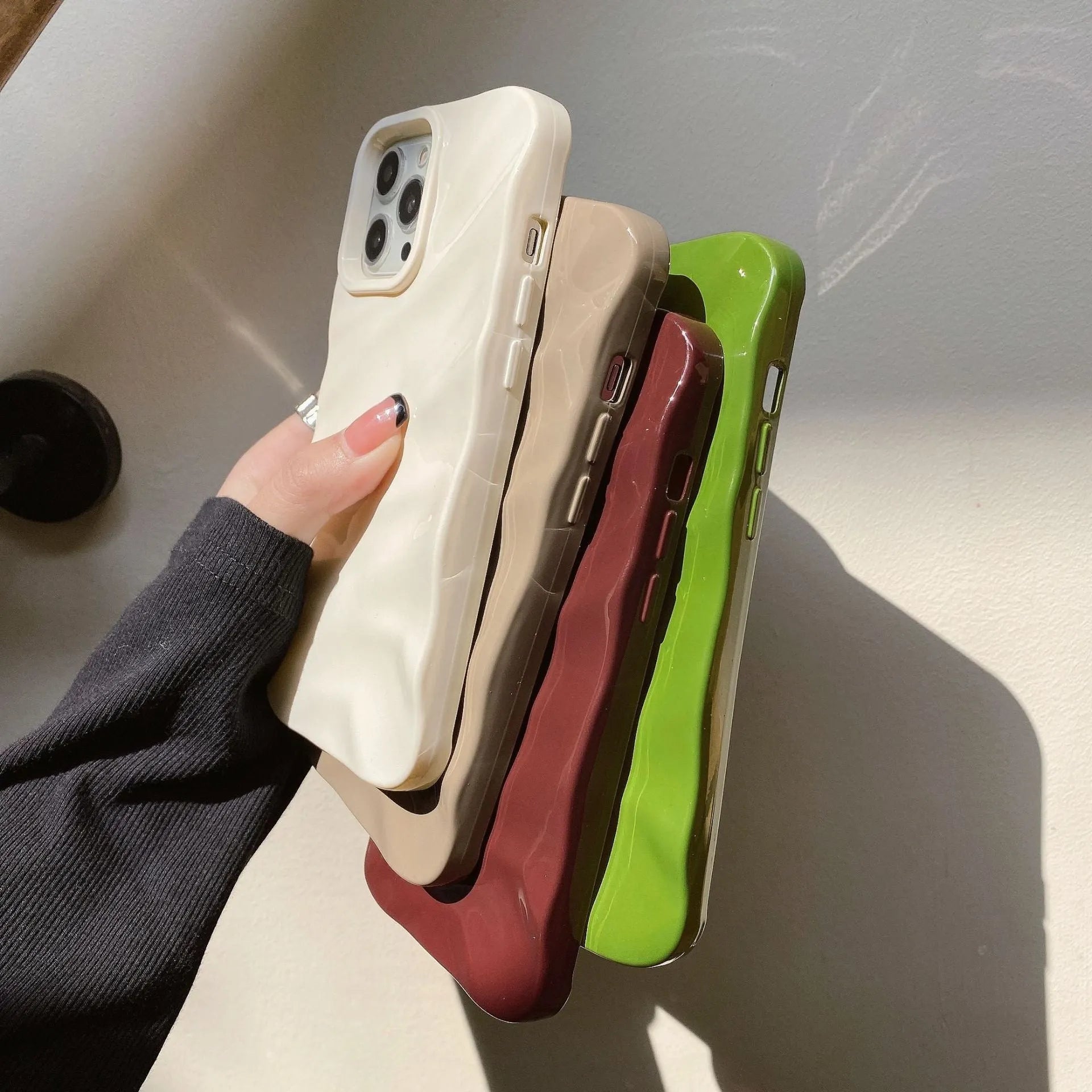 Soft wave-patterned TPU phone case for Apple iPhone 17 models in burgundy colour.