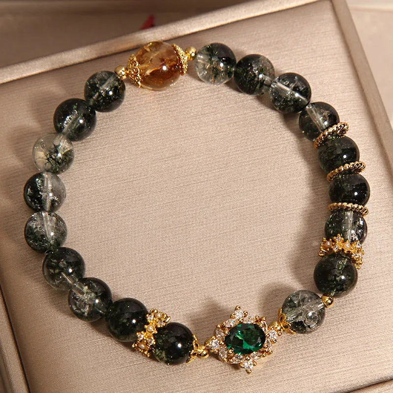 Women's green phantom quartz crystal bracelet with gold rutile needle inclusions and rhinestone accents