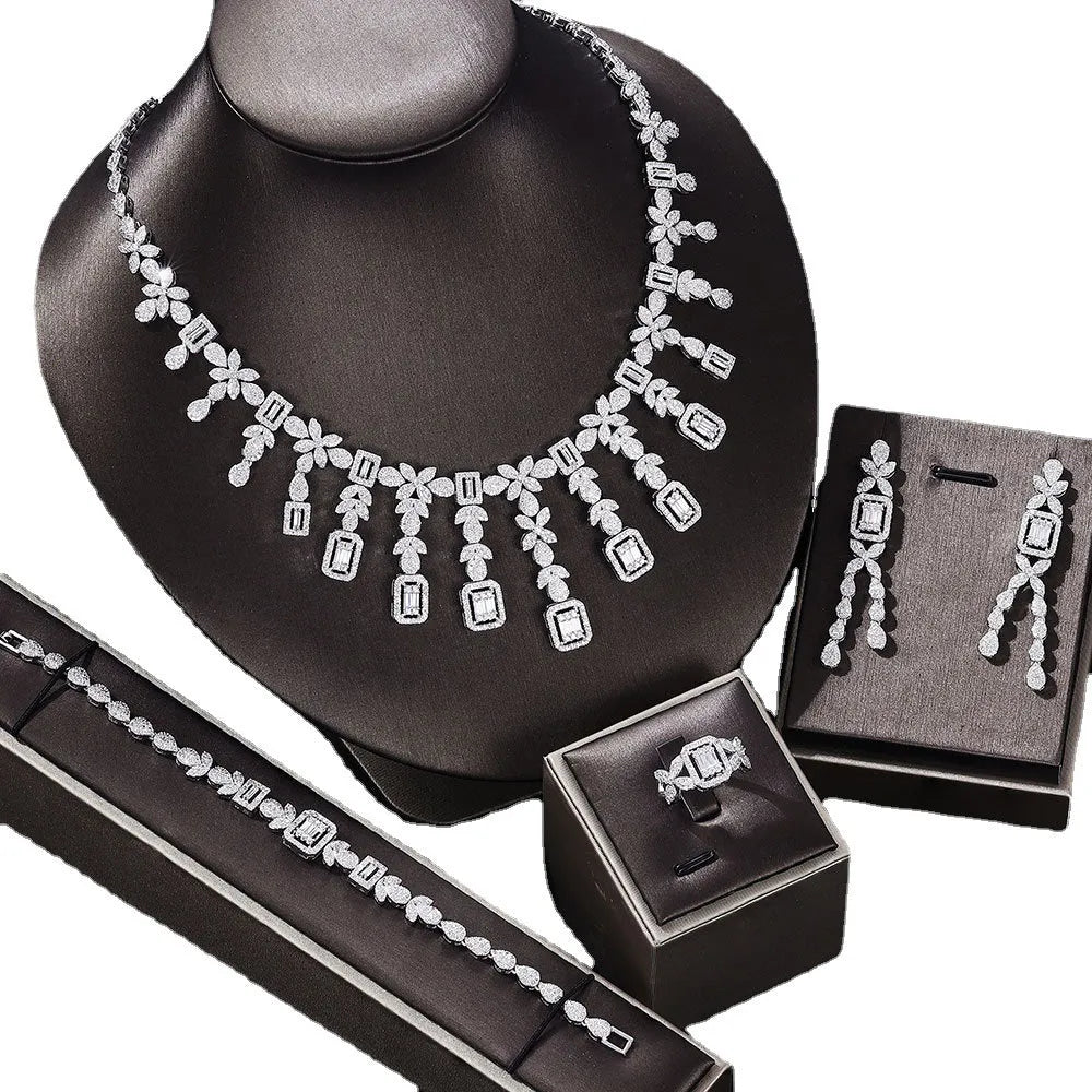 White copper inlaid zircon four piece jewellery set with love heart, water drop, and bell patterns including necklace, earrings, bracelet, and ring