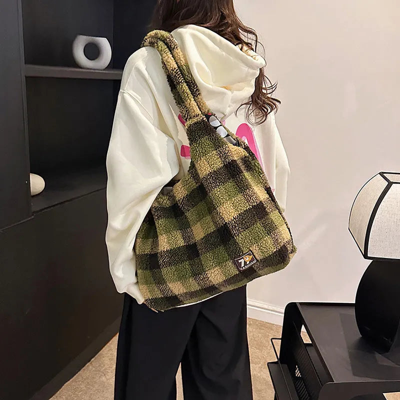 Women's plaid pattern plush crossbody tote bag showing interior zipper compartment and strap design
