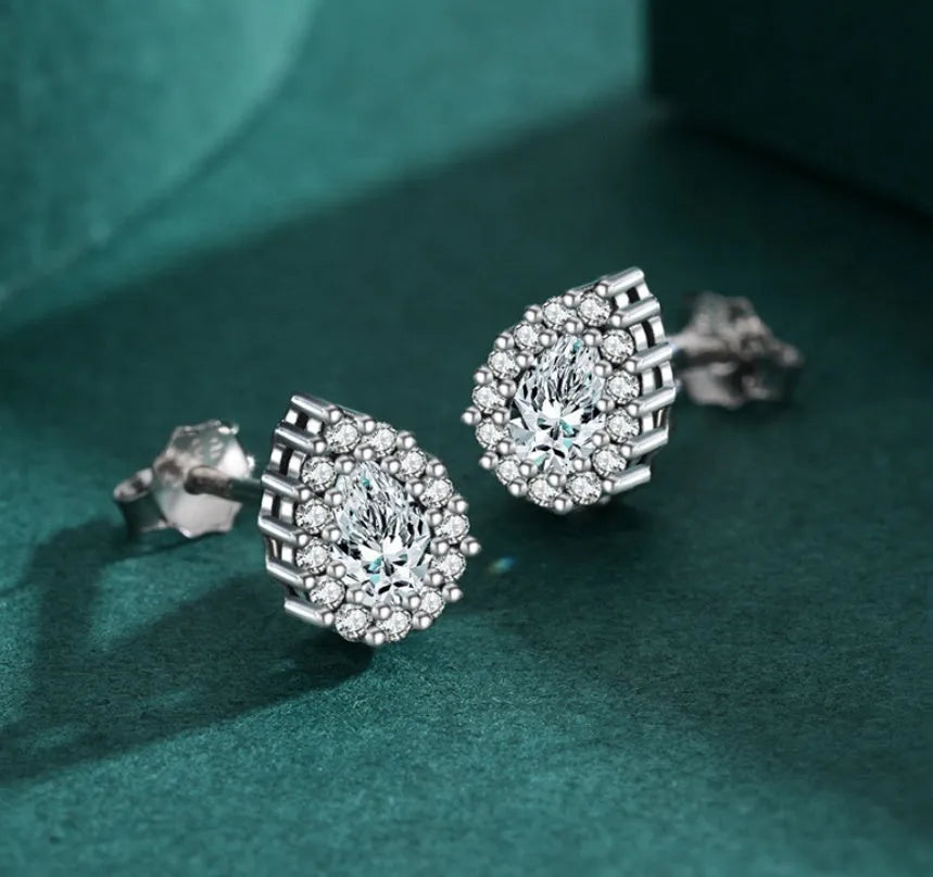 Close-up of a women's sterling silver drop ear stud with a polished finish and diamond-treated detail.