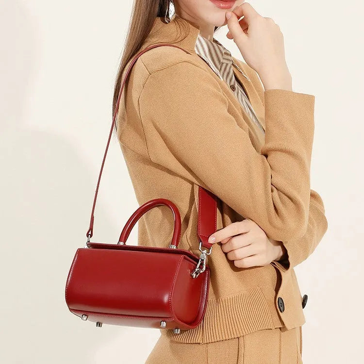 Women's cowhide leather crossbody bag in clamshell design with single shoulder strap