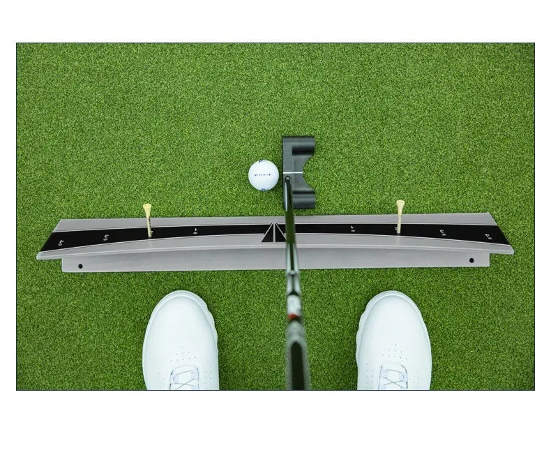 Golf putter resting against the adjustable PVC push rod balancer of the trajectory balance simulator on a carpet.