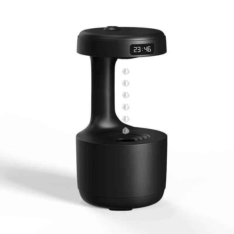 White anti-gravity humidifier showing water droplets levitating upwards from its mist outlet.