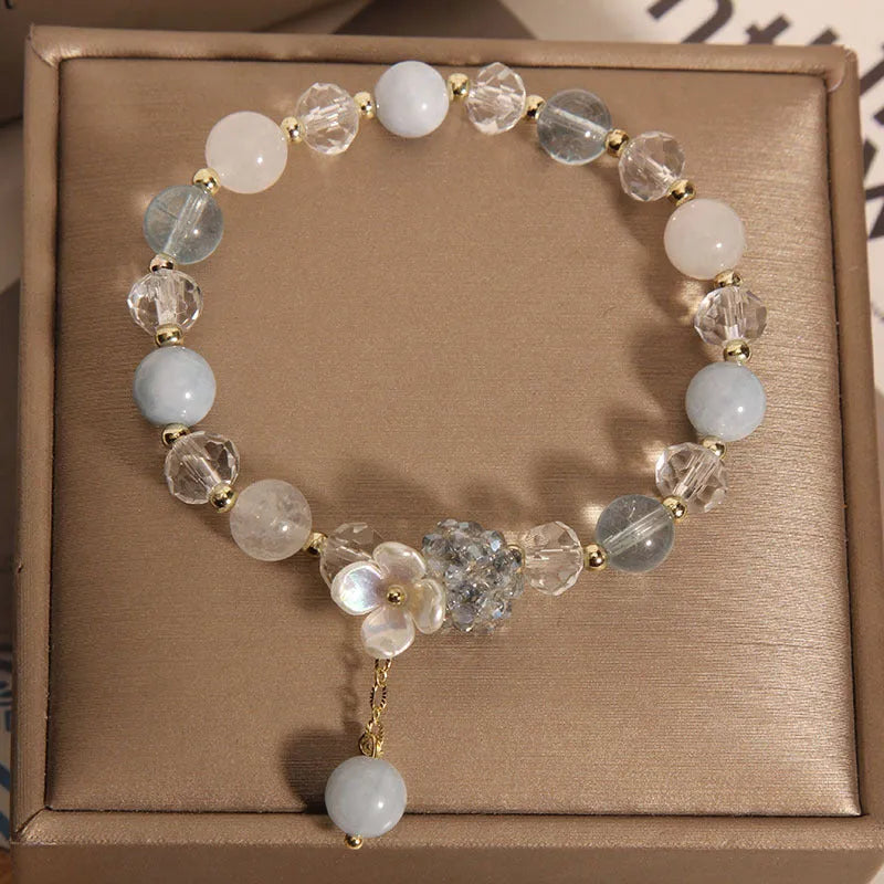 Woven aquamarine crystal bracelet with opal floral elements and cat motifs