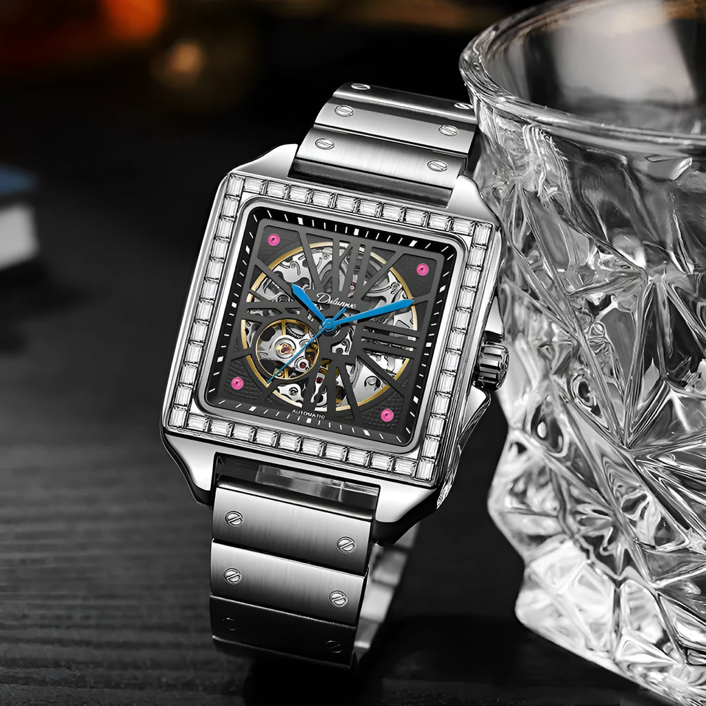Men's square automatic watch with diamond-studded case on a black leather strap.