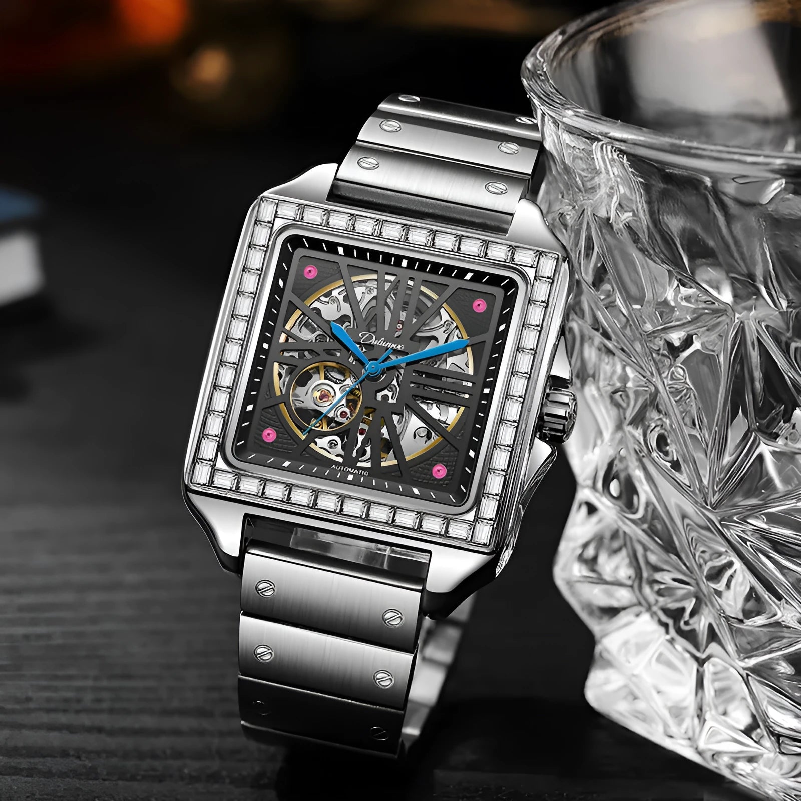 Men's square automatic watch with diamond-studded case on a black leather strap.