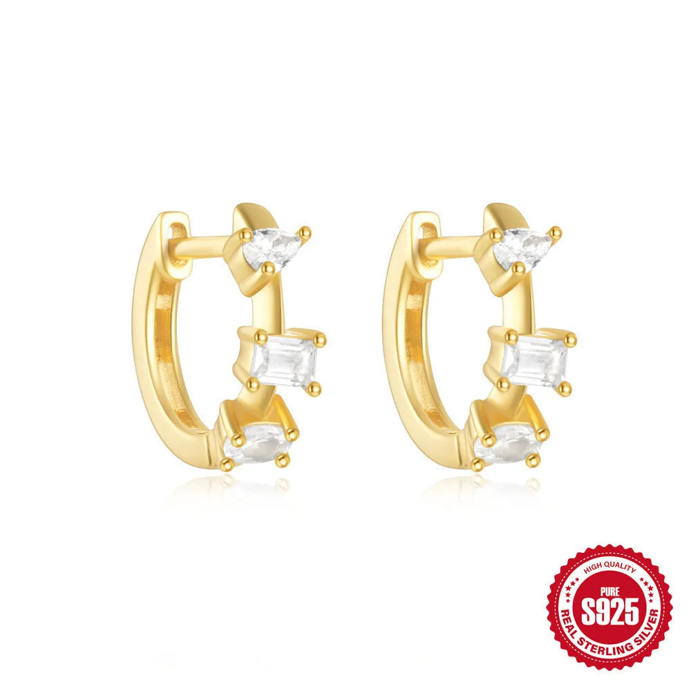 A pair of small round sterling silver geometric stud earrings with a classic diamond detail on a plain background.