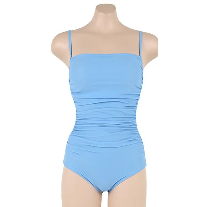 Blue sling style one-piece swimsuit with belly pleats and slim fit on model.