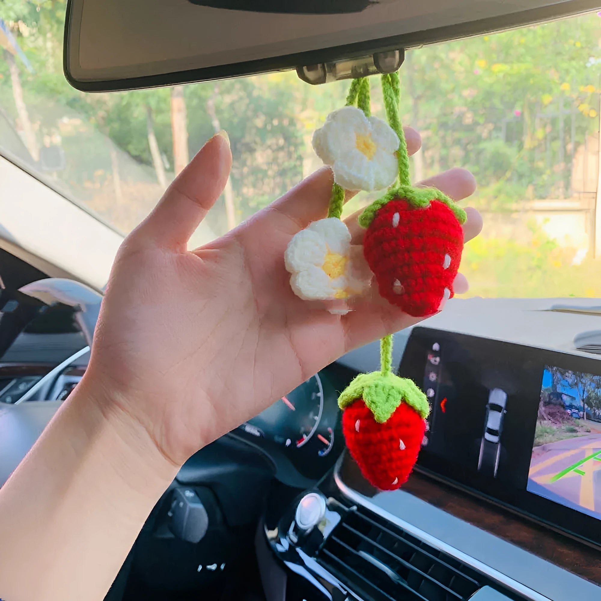 Handmade woven strawberry-shaped car pendant made from cotton and hemp yarn.