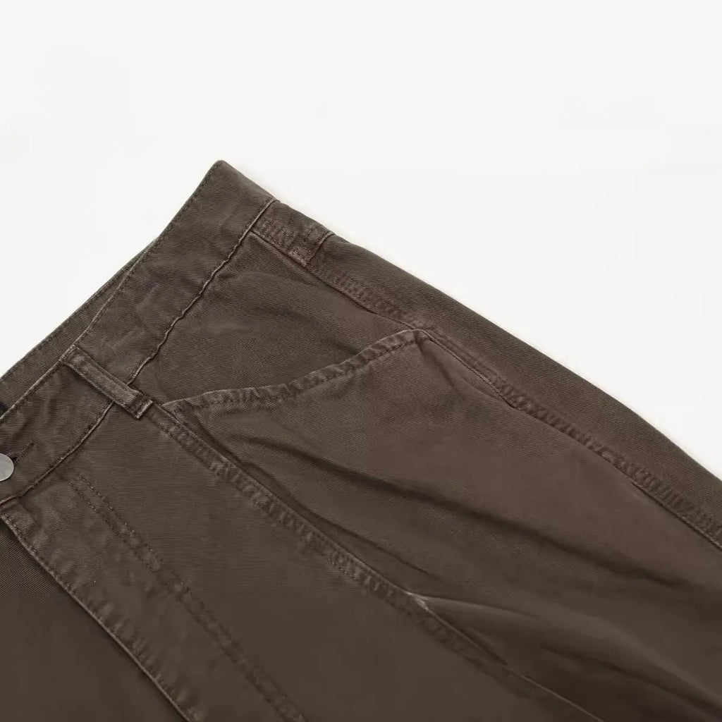 Men's brown loose-fit straight leg trousers with a high waist and wide-leg style on a hanger.