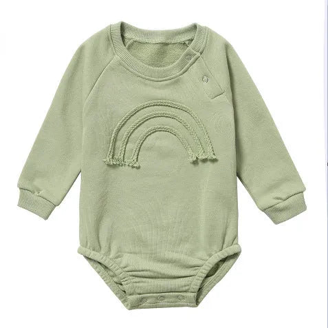 Infant wearing a beige waffle cotton long sleeve romper climbing suit
