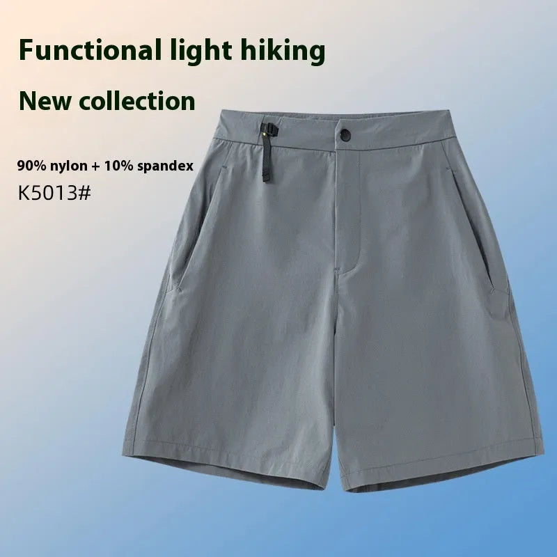 Man wearing khaki athletic shorts with four-way stretch, demonstrating movement for running or climbing.