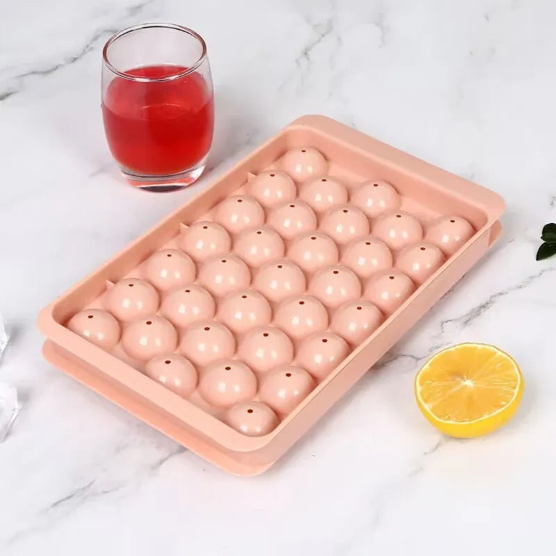 Blue silicone ice cube tray with lid showing 33 round grids for making ice.
