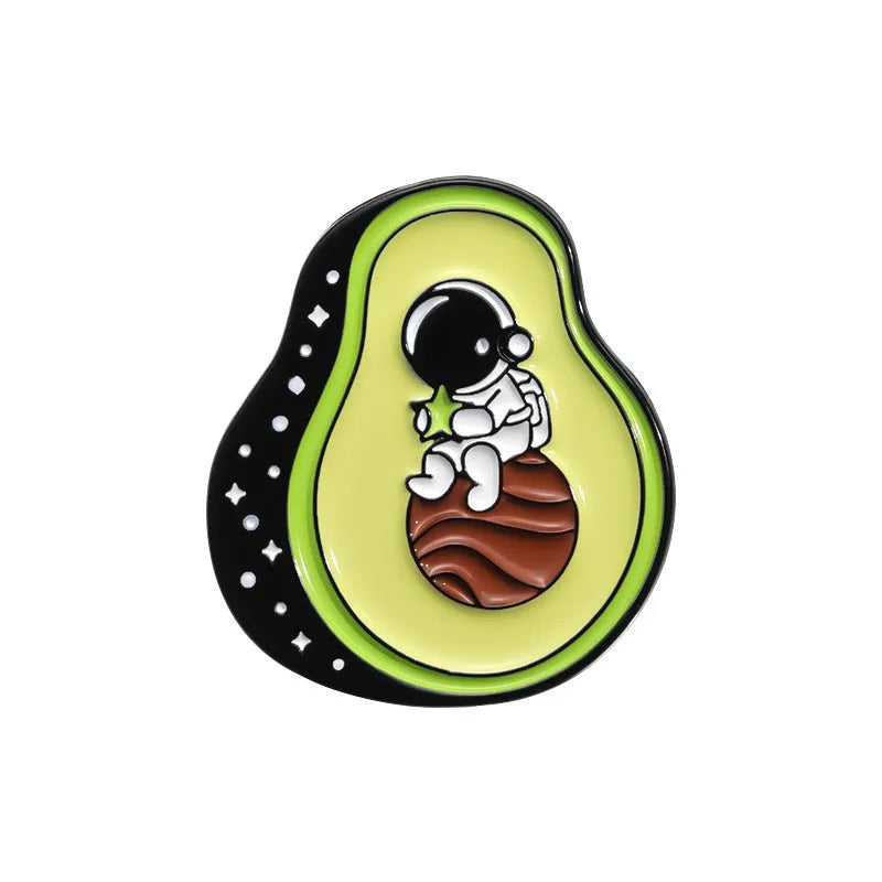 Colourful cartoon-style fruit metal brooch with pin clasp on a denim jacket lapel.