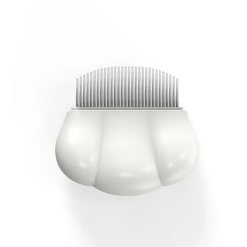 Paw Soft deshedding grooming brush for cats and dogs on a white surface.