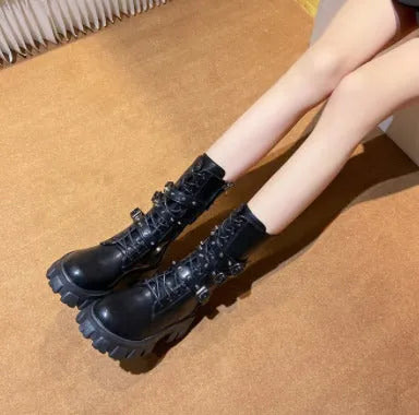 A pair of black women's mid-calf boots with a side zip and a round toe, showing the metal buckle detail.