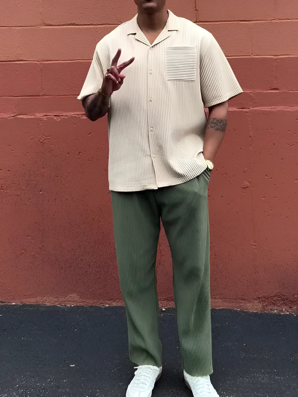 Green men's pleated casual trousers showing ankle-length cut and regular fit