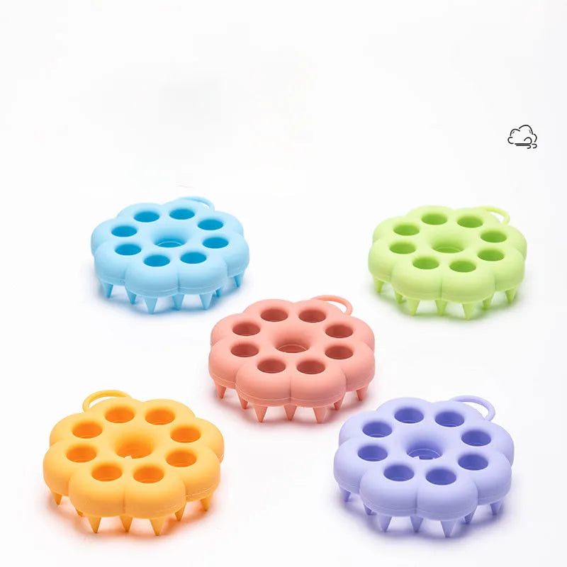 Handheld silicone pet grooming brush for wet and dry use, shown in assorted colours.