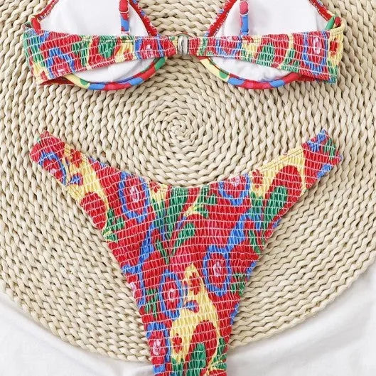 Red floral patterned women's underwire triangle bikini top and briefs on a mannequin.