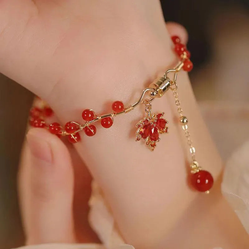 Red ginkgo leaf charm on an alloy magnetic bracelet with Chinese style design.