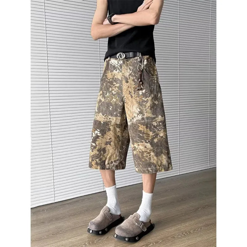 Yellow denim jeans with a snake camouflage pattern and cropped leg hem.
