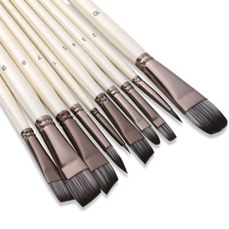 Set of ten pearl white nylon watercolour brushes with wood handles on a table.