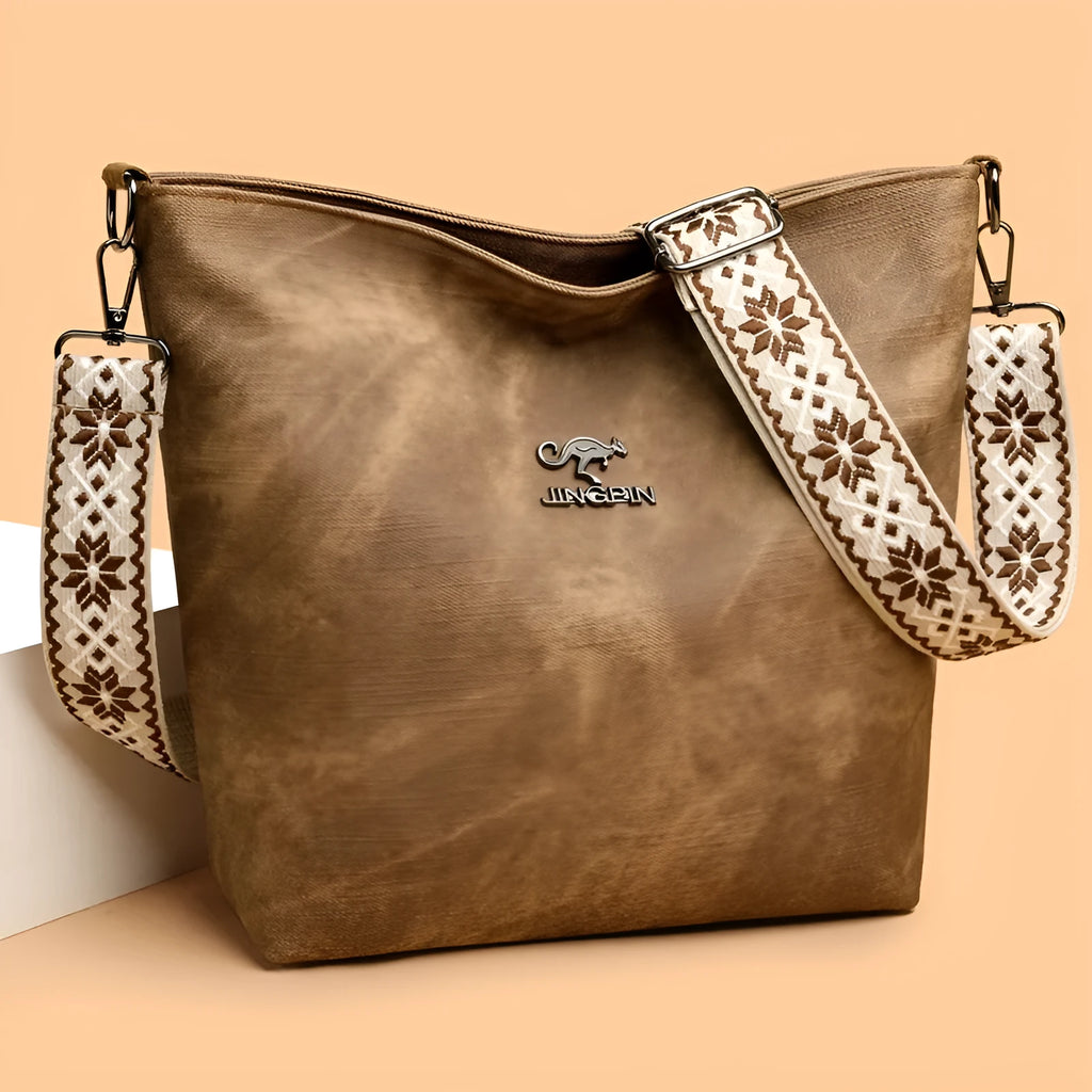 Soft grey PU crossbody bag with adjustable strap on mannequin