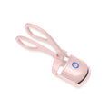 White and pink USB rechargeable heated eyelash curler with temperature control settings.