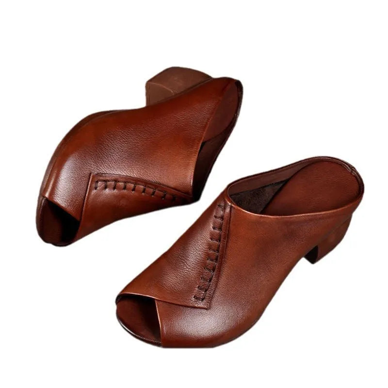 A pair of women's black square heel peep-toe slippers with an open fish mouth design.