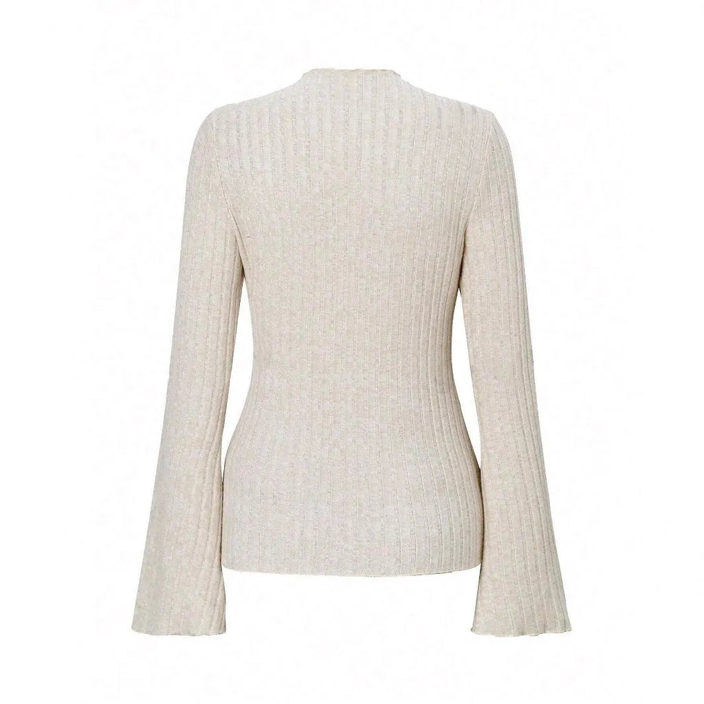 A person wearing a black long sleeve round neck top with a brushed sunken stripe texture and lantern sleeves.