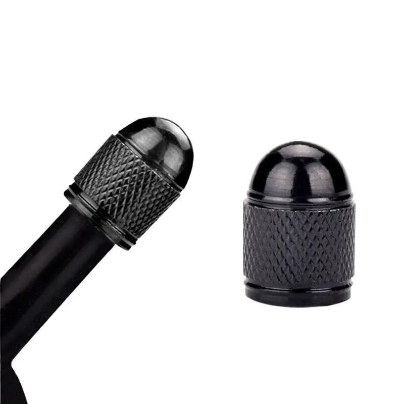 Aluminium alloy bicycle tyre valve cap in assorted colours on a black background.