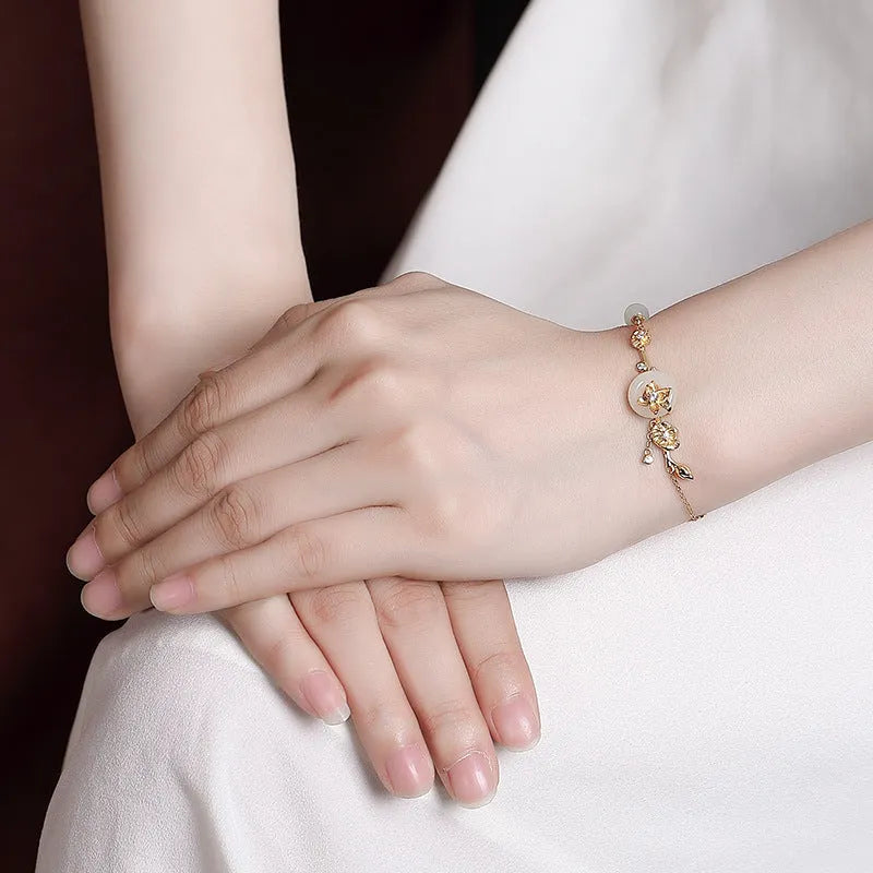 Women's retro bracelet with Hetian jade lotus peace buckle design in 925 silver