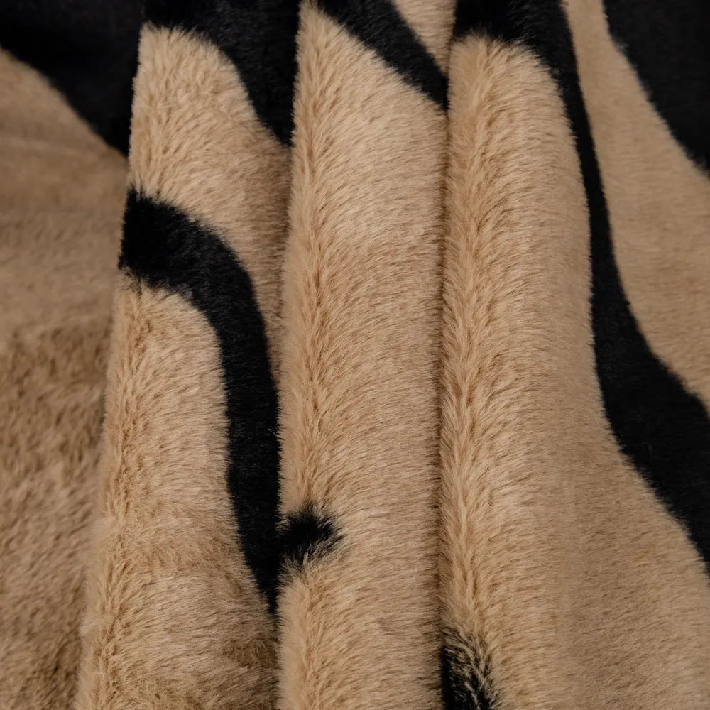 Zebra pattern flannel sofa cover in caramel colour on a sofa, showing non-slip fit and matching pillowcase.