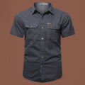 Men's army green cotton short sleeve work shirt with a loose cardigan fit on a hanger