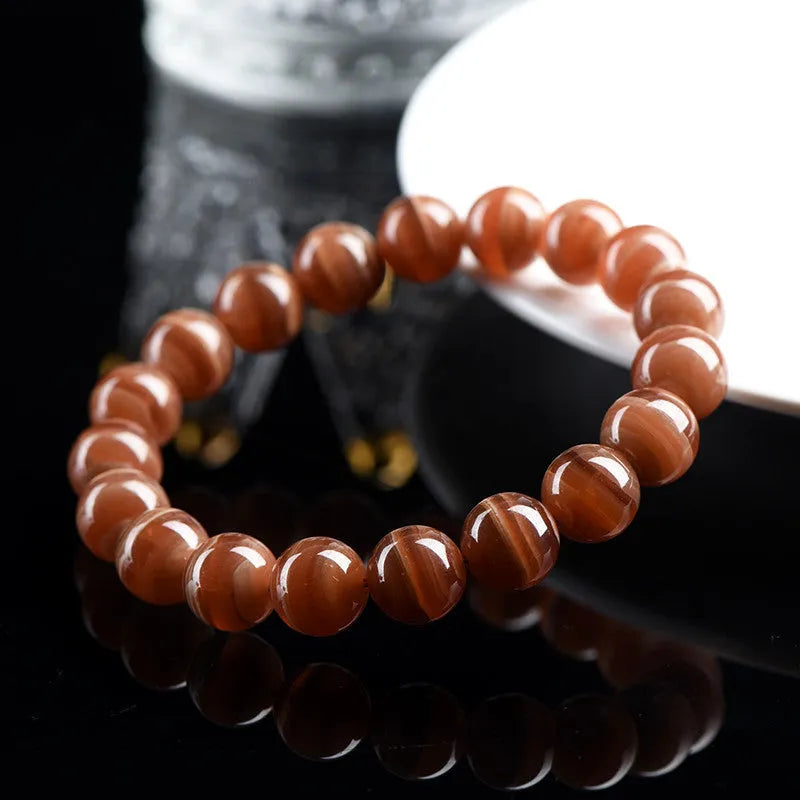 Natural old mine rhodochrosite round bead bracelet from Peru with ruyi charms.