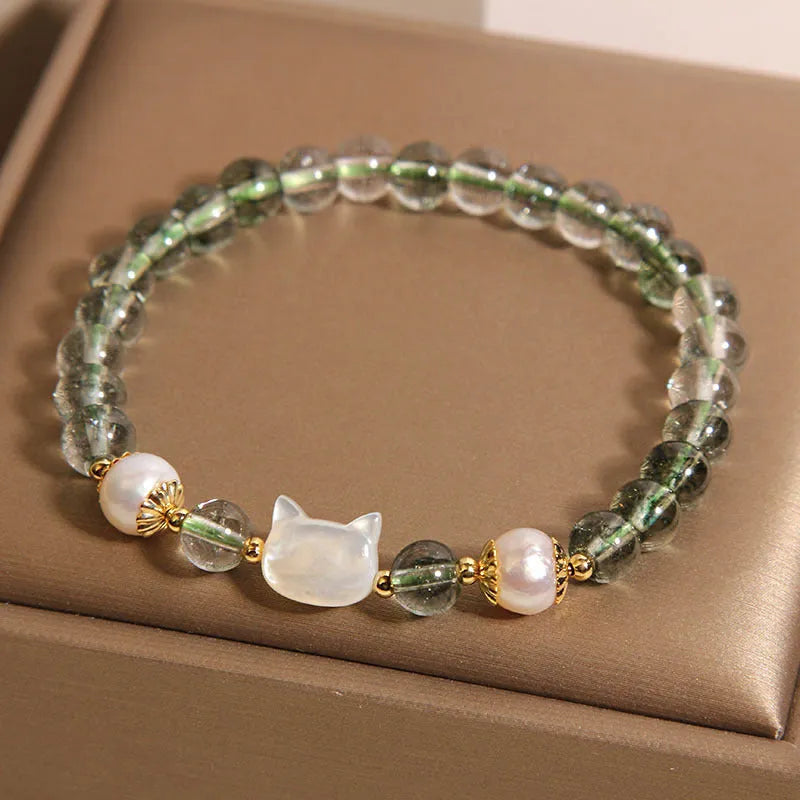 Green Phantom Quartz crystal bracelet with a detailed Shell Kitten charm on a women's wrist.