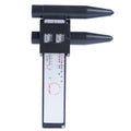 Digital electronic plastic caliper hole distance ruler on a workbench.
