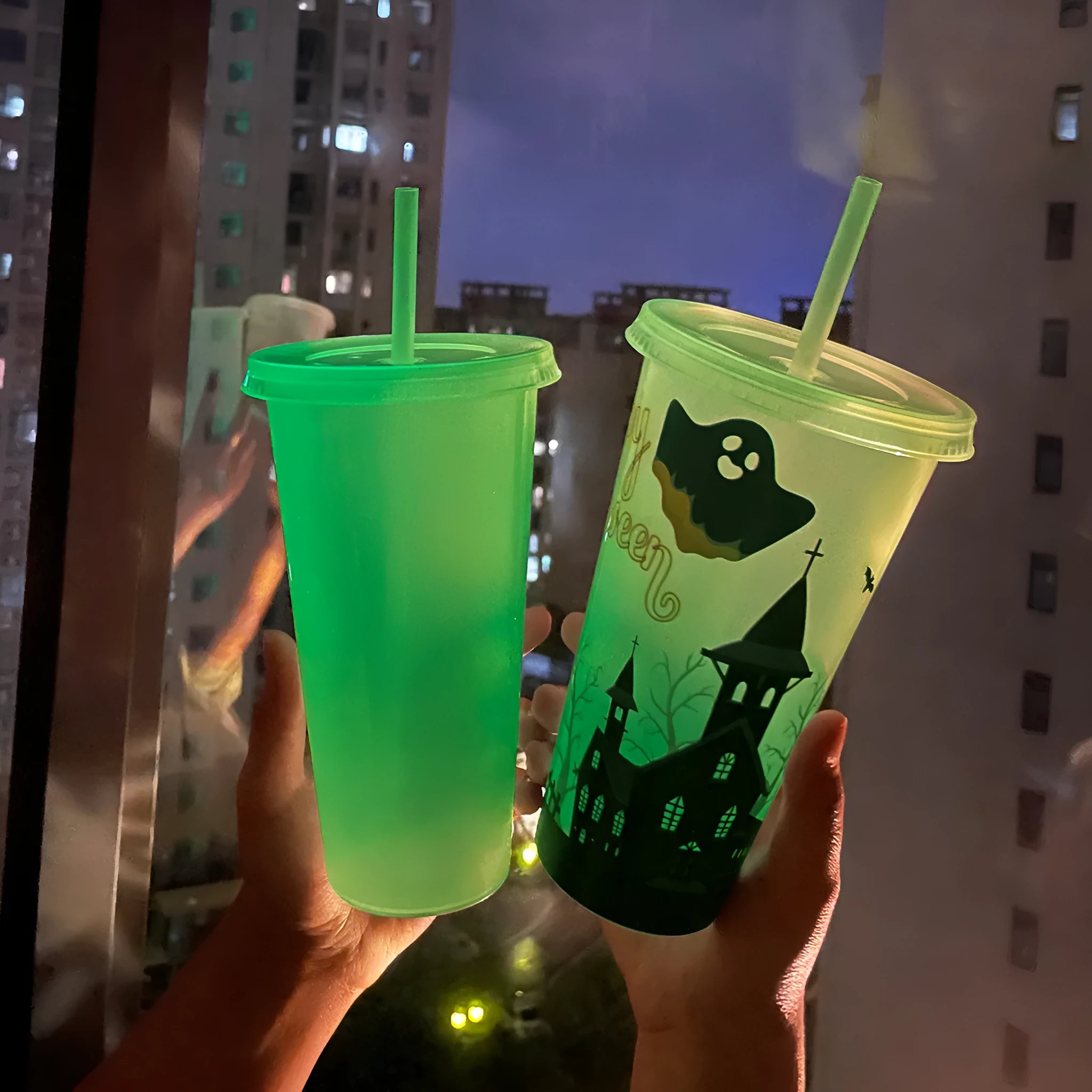 A tall 720ml luminous Halloween-themed plastic cup with a straw, showing colourful design.