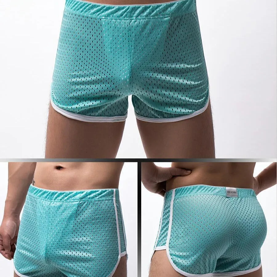 Men's cotton three-point boxer shorts in light blue, laid flat to show mid-waist design and trunk style.
