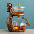 Maid semi-automatic glass teapot set with heat-resistant base and stainless steel tea infuser on a tea tray