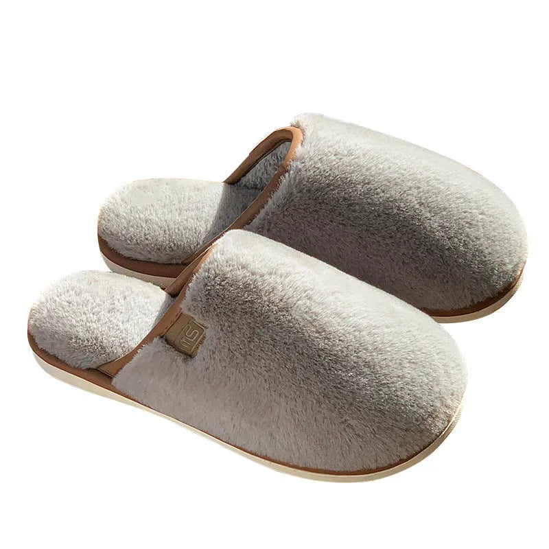Solid colour plush slippers with PVC non-slip sole and car stitching detail on the upper.
