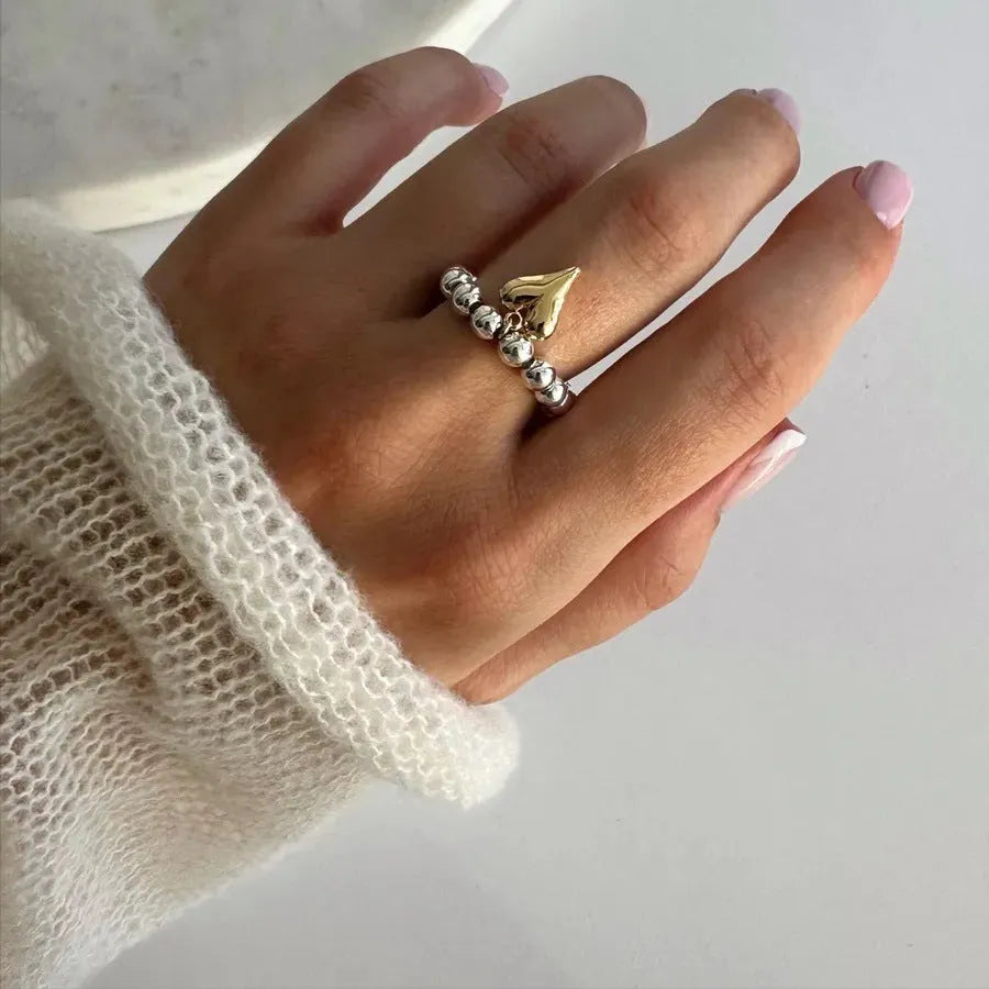 Handmade beaded elastic string love ring with geometric heart design in electroplated colours