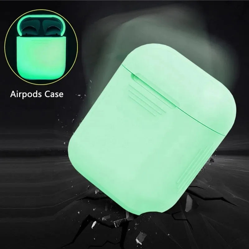 Glow-in-the-dark silicone flip-top protective case for Apple AirPods on a dark background.