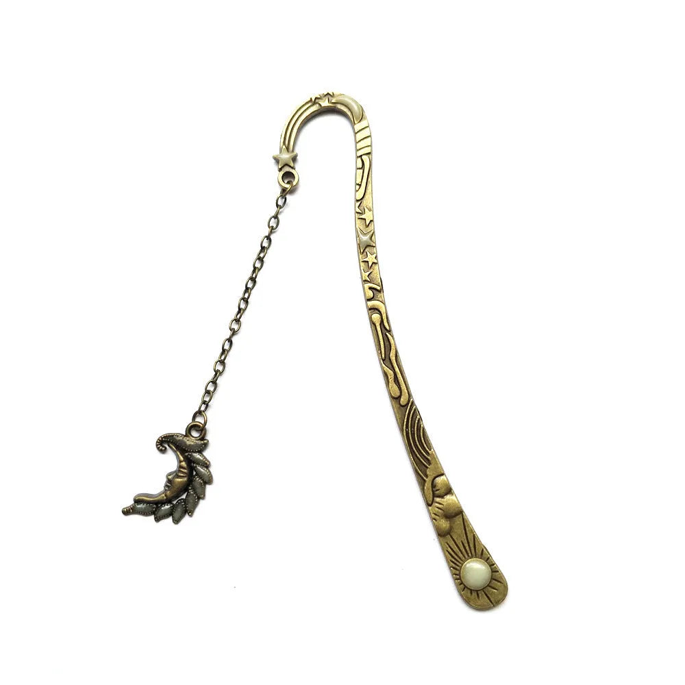 Metal bookmark with glowing five-pointed star and celestial sun moon stars design