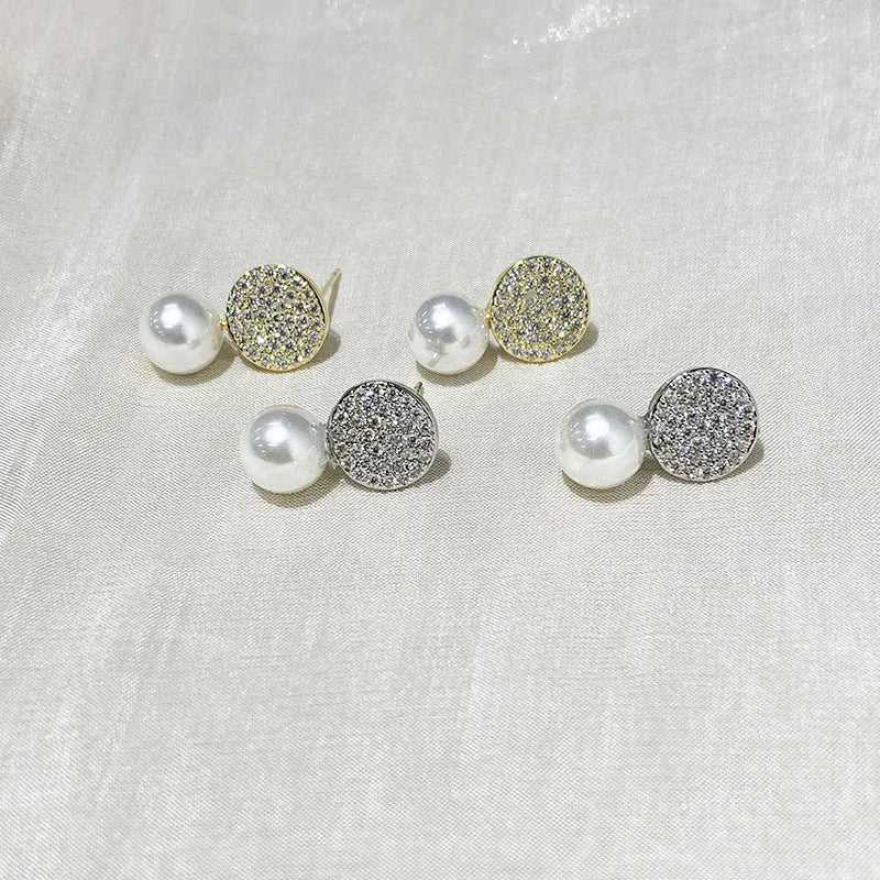 Round diamond studded pearl earrings in gold finish with post back closure
